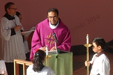 Father Karippai reads the Gospel